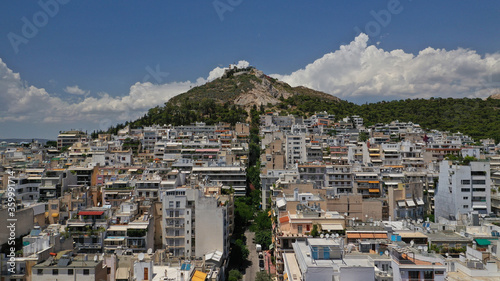 Aerial drone panoramic photo of Lycabettus hill and Athens urban cityscape with beautiful sky and clouds, Attica, Greece