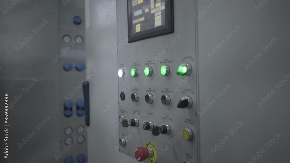 Male hand in gloves adjusting machinery in factory. Unrecognizable professional machine operator pushing buttons on industrial equipment on production line. Manufacture, industry. Male hand in gloves adjusting machinery in factory. Unrecognizable professional machine operator pushing buttons on industrial equipment on production line. Manufacture, industry.