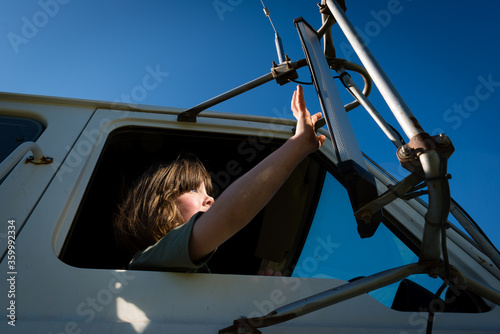 Low angle view of girl sitting in truck
