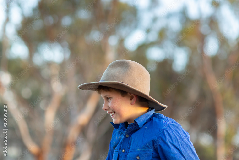 Country kid wearing felt hat head and shoulders in profile Country kid wearing felt hat head and shoulders in profile