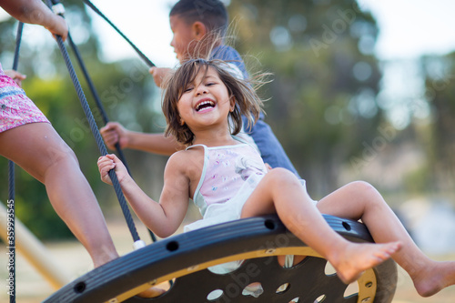 Kids playing on a swing in a playground