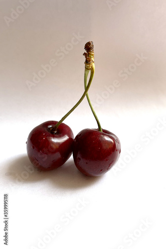 two cherries on a white