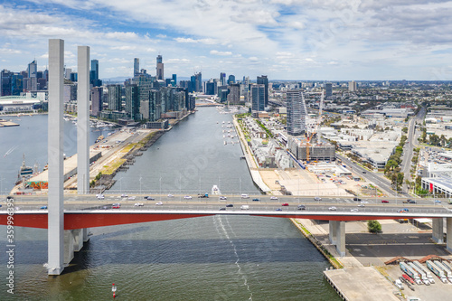 Aerial view of the Bolte Bridge over the Yarra River and Melbourne city skyline in the background photo