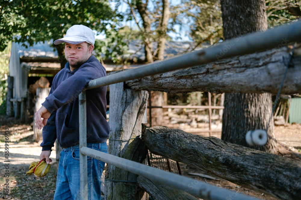 Man Holding open Farm Gate Man Holding open Farm Gate