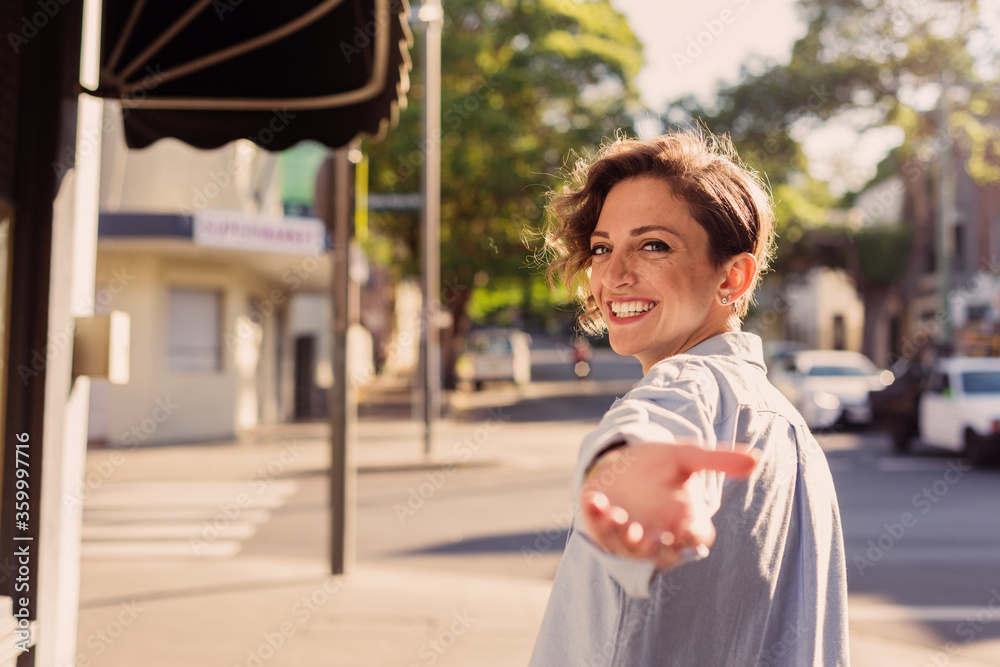 woman reaching back with hand out woman reaching back with hand out