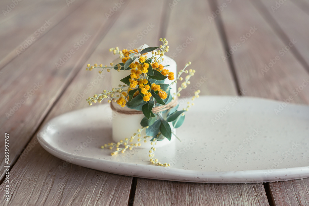 candle with wattle flower candle with wattle flower