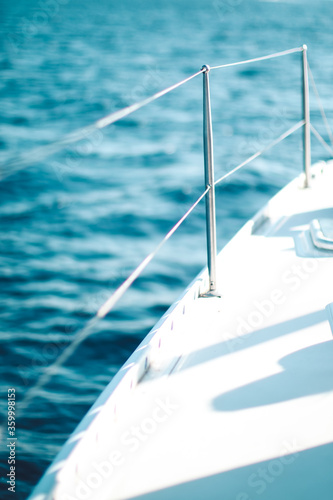 Close up of the wire railing of a boat on the ocean photo