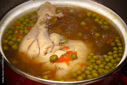 Boiling chicken pea soup in pan