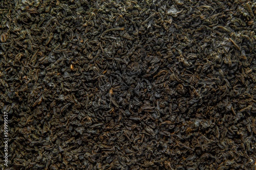 Black tea as a background. Black tea is scattered. Tea leaves are dried.