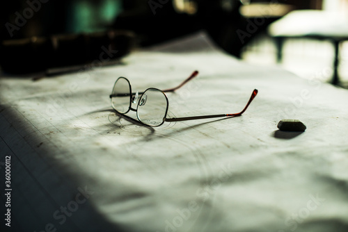 Glasses sitting on technical plans