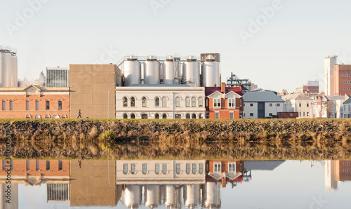 Brewery building on the side of the Tamar River, the building is reflected on the rivers surface photo