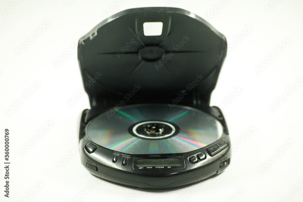 old pocket disc player with headphones and an open lid for a laser disc on a white background old pocket disc player with headphones and an open lid for a laser disc on a white background