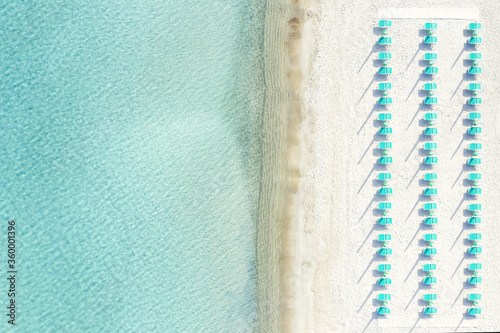 Obraz na płótnie View from above, stunning aerial view of a white sand beach with beach umbrellas and a beautiful turquoise sea. Marinella Beach, Porto Rotondo,Sardinia, Italy. w salonie