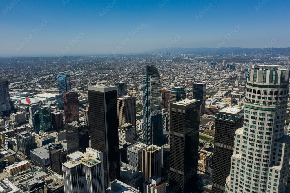 Obraz premium Drone view of high rises and skyscrapers in Los Angeles downtown on a sunny day in California