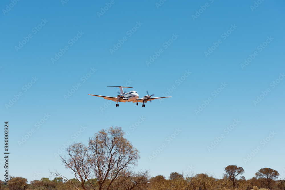 Small charter plane landing at remote air strip Small charter plane landing at remote air strip