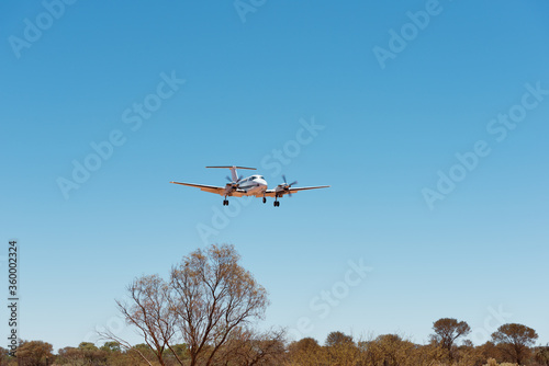 Small charter plane landing at remote air strip