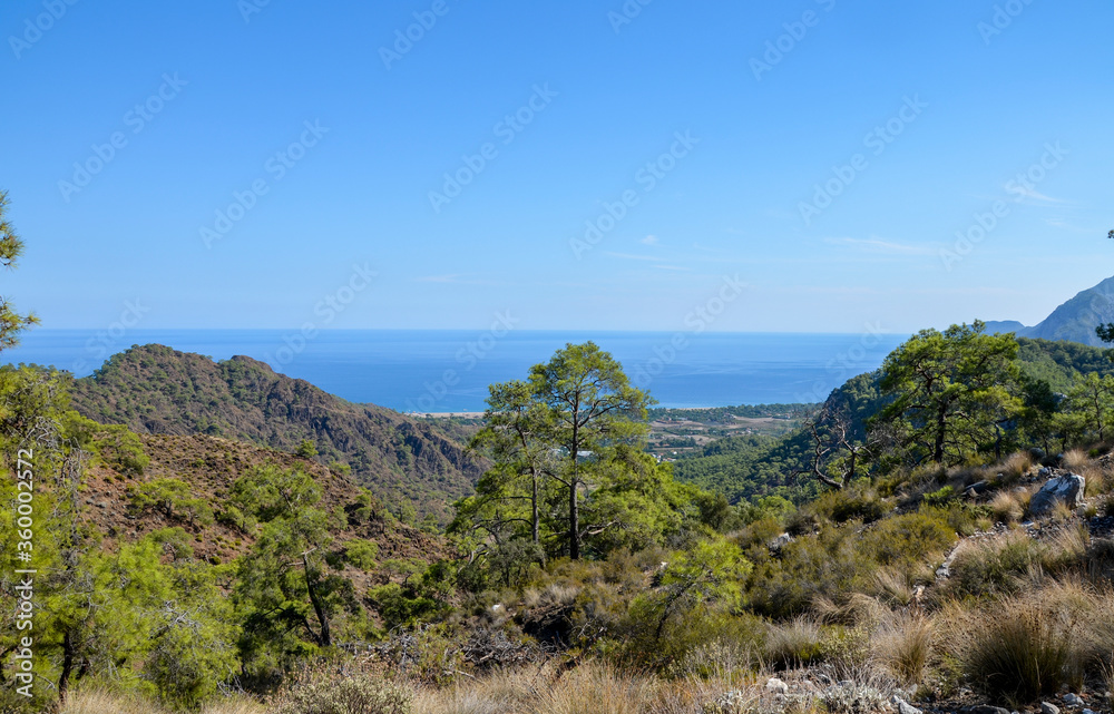 View from the top on rocks, beaches and sea. Beautiful nature landscapes in Turkey mountains. Lycian way is famous among hikers. View from the top on rocks, beaches and sea. Beautiful nature landscapes in Turkey mountains. Lycian way is famous among hikers.