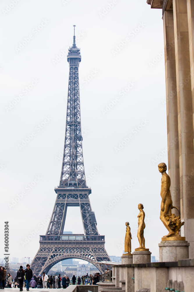 Tourists at the famous Tour Eiffel in Paris in a cold winter day