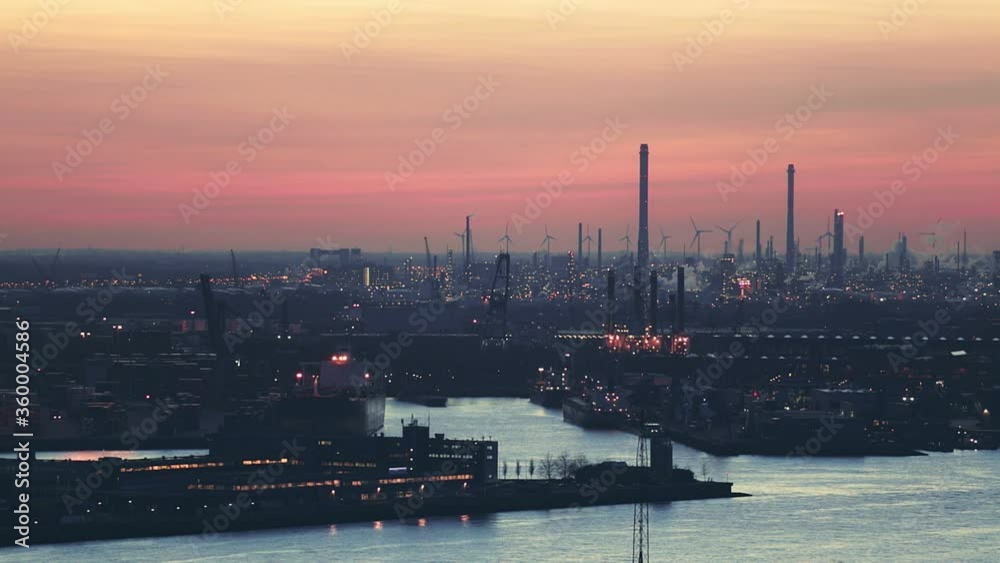 Static footage of loading and unloading docks at the Port of Rotterdam by evening.