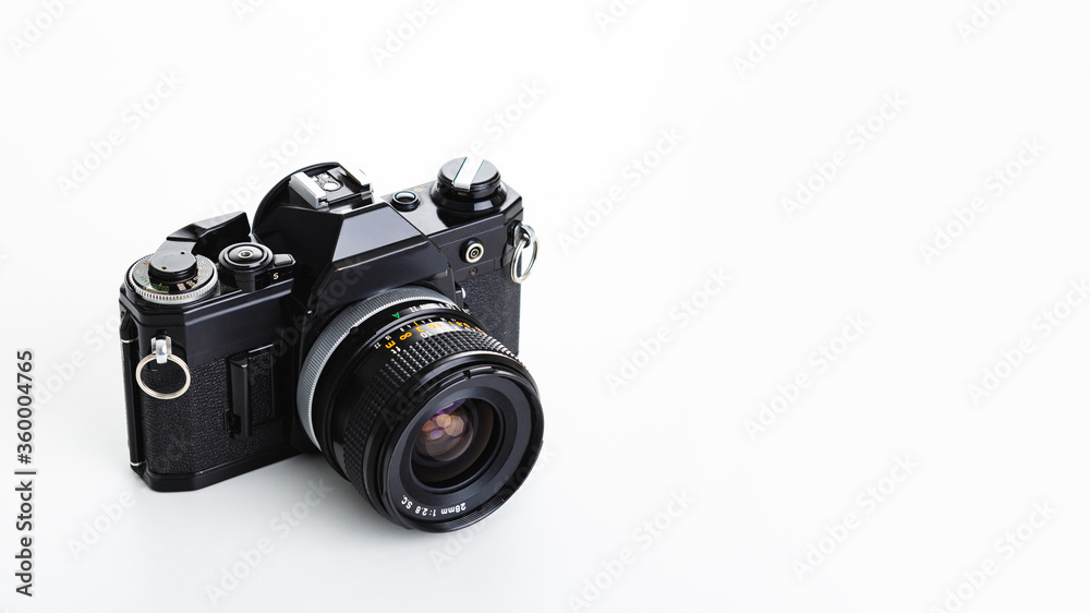 Fototapeta premium Black analogue camera. Isolated white background. Space for text