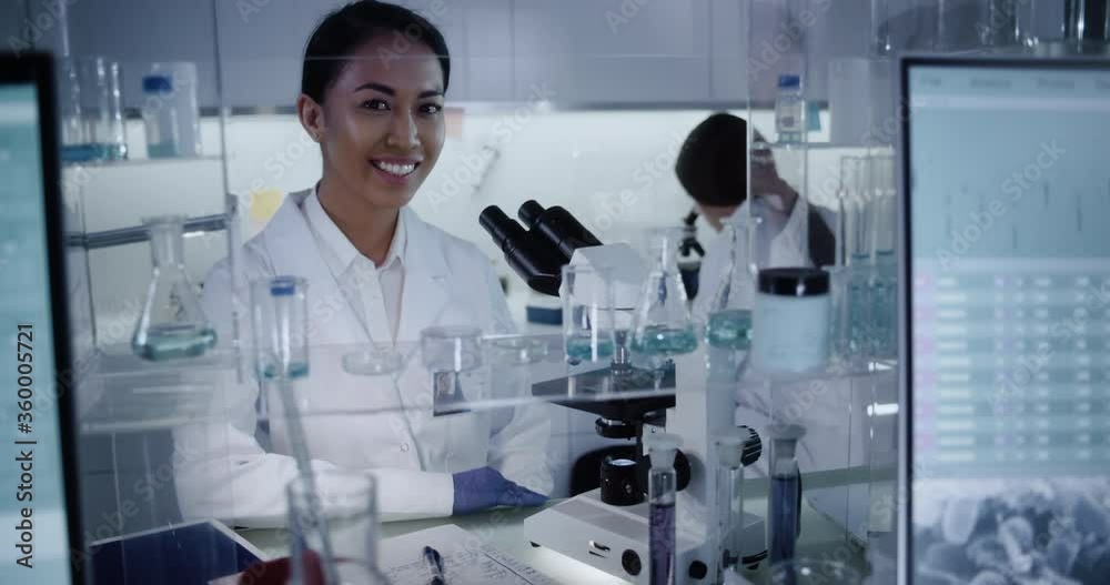Female team working in modern laboratory. Studying genetic material with microscope. Medical sample research Female team working in modern laboratory. Studying genetic material with microscope. Medical sample research