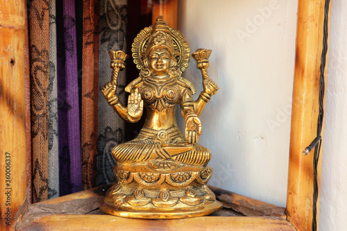 Bronze statuette of Lakshmi on the lotus with a blessing gesture.