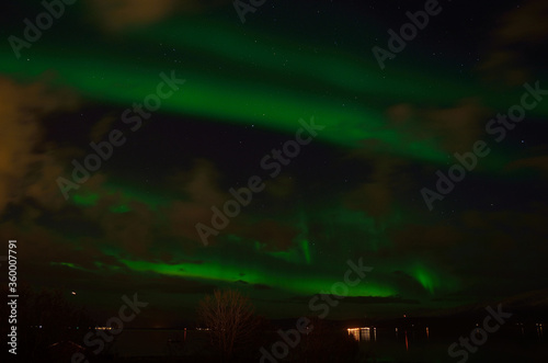 strong vibrant aurora borealis, northern light in autumn night in the arctic circle © Arcticphotoworks