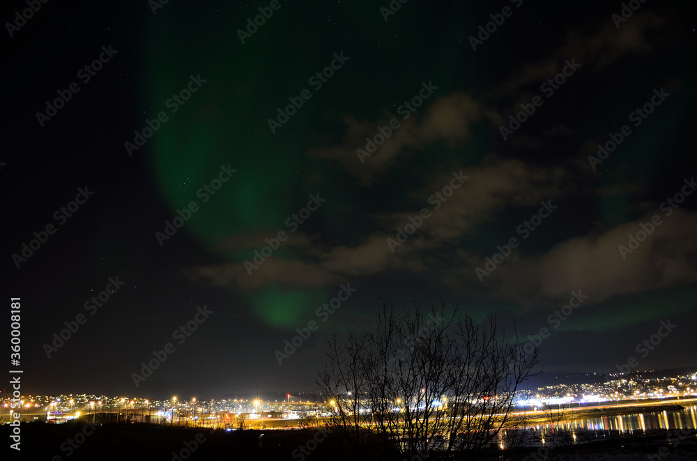 beautiful aurora borealis over the arctic city of tromsoe on a late autumn night
