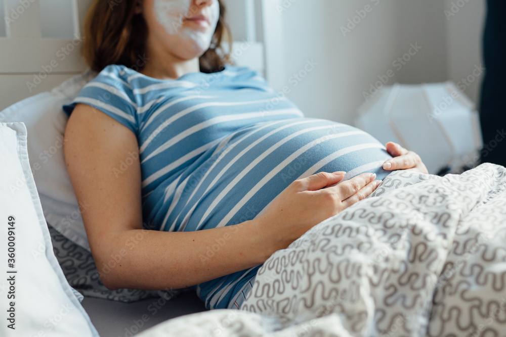 Pregnant woman laying in bed Pregnant woman laying in bed