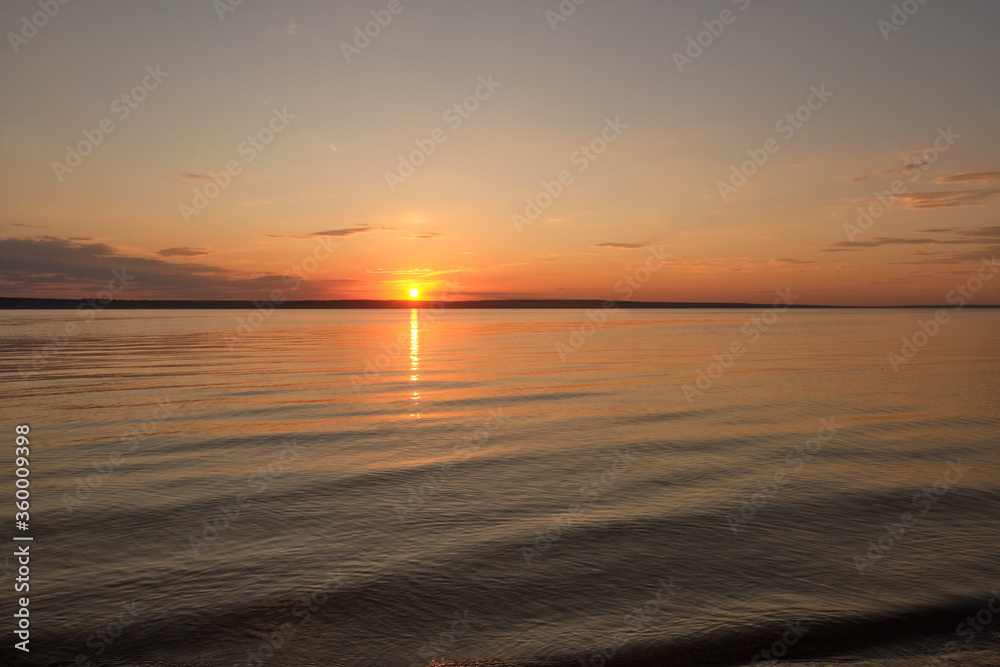 Colorful ocean beach sunrise with deep blue sky and sun rays. Colorful ocean beach sunrise with deep blue sky and sun rays.