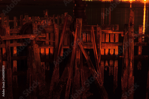 weathered wooden pier at night