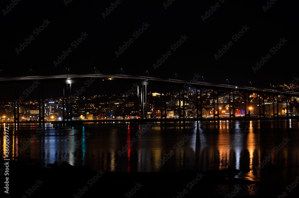tromsoe city island at night with the bridge connecting the island to the mainland