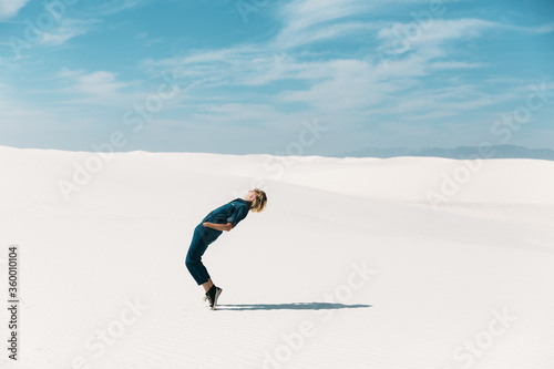 Adventure Woman Walking Through White Sand Dunes