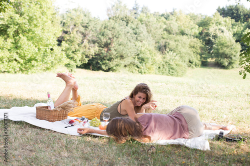 Two girls are having a picnic in the nature photo