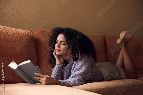 Female student reading at home photo