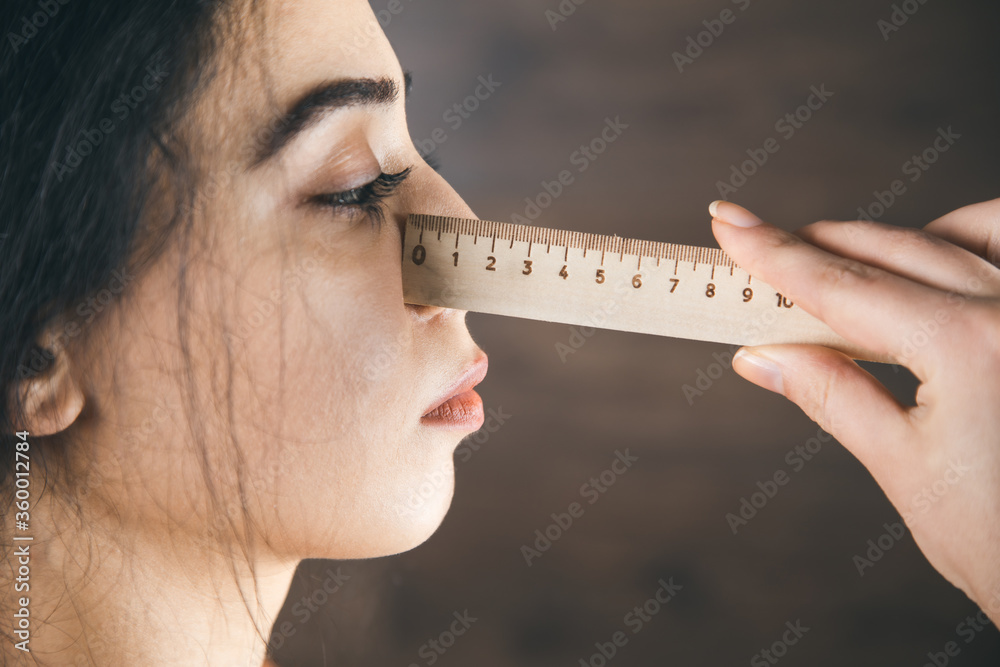 Measure the nose with a ruler Stock Photo Adobe Stock