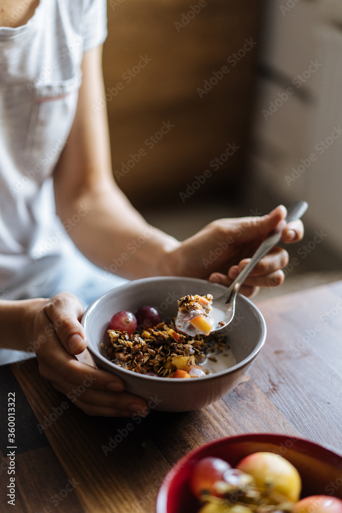 Crop woman eating muesli in morning Crop woman eating muesli in morning