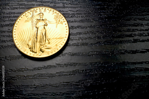Liberty inscription on a gold 1 ounce American Eagle coin made in the US mint.