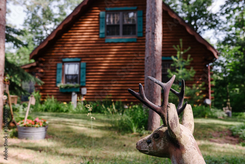 Deer Statue by a Cabin