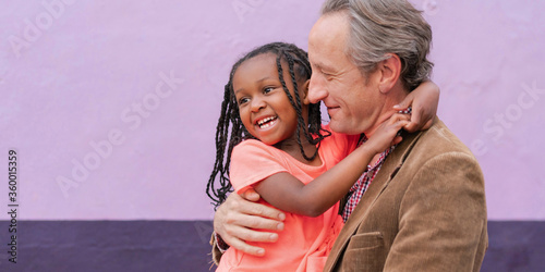 Father holding his multi ethnic daughter
