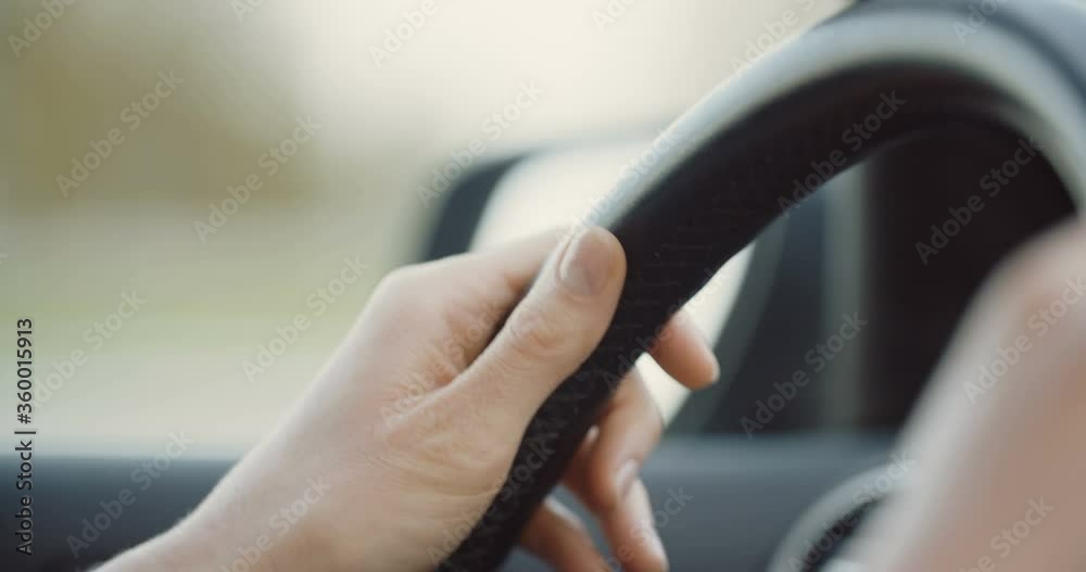 Slow motion closeup of female hands on a steering wheel. Slow motion closeup of female hands on a steering wheel.
