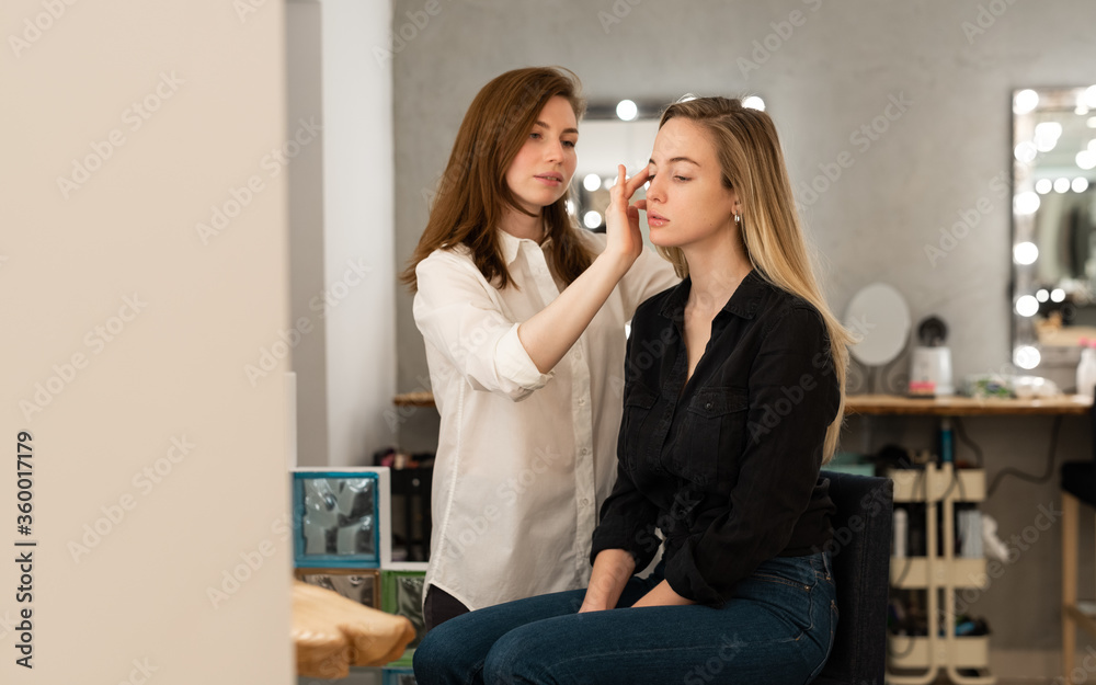 Makeup artist applying foundation on model Makeup artist applying foundation on model