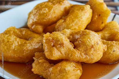 Picarones: These are ring-shaped dessert made ​​with wheat flour dough mixed with pumpkin and sweet potato. fried and dipped in fig molasses. An authentic and traditional dessert of Peruvian cuisine. © Dedvyned