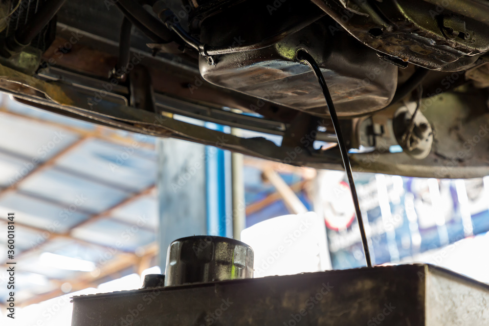 Drain the old oil from the engine through the drain plug. Changing the