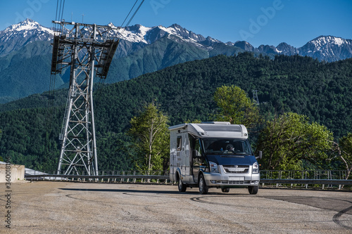 A house on wheels. A motorhome. Rv. Camper. Rest in the mountains. A residential van. Independence. High mountains. Freedom. Tourism. Journey. photo