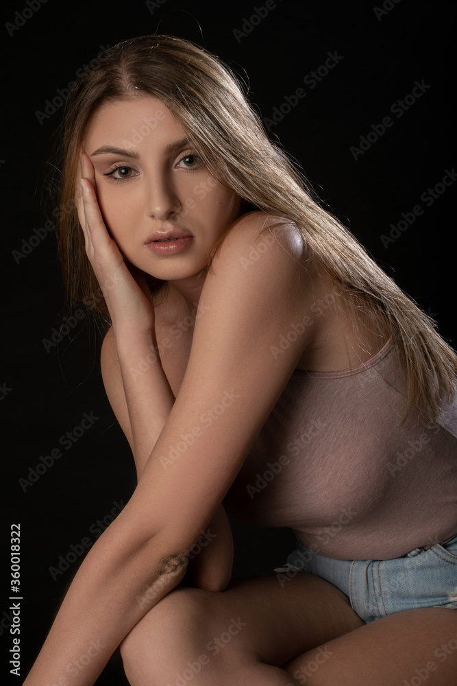 Beautiful girl posing on black background. Isolated, Face Expression Beautiful girl posing on black background. Isolated, Face Expression