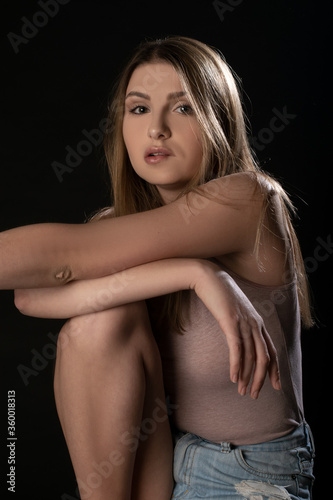 Beautiful girl posing on black background. Isolated, Face Expression