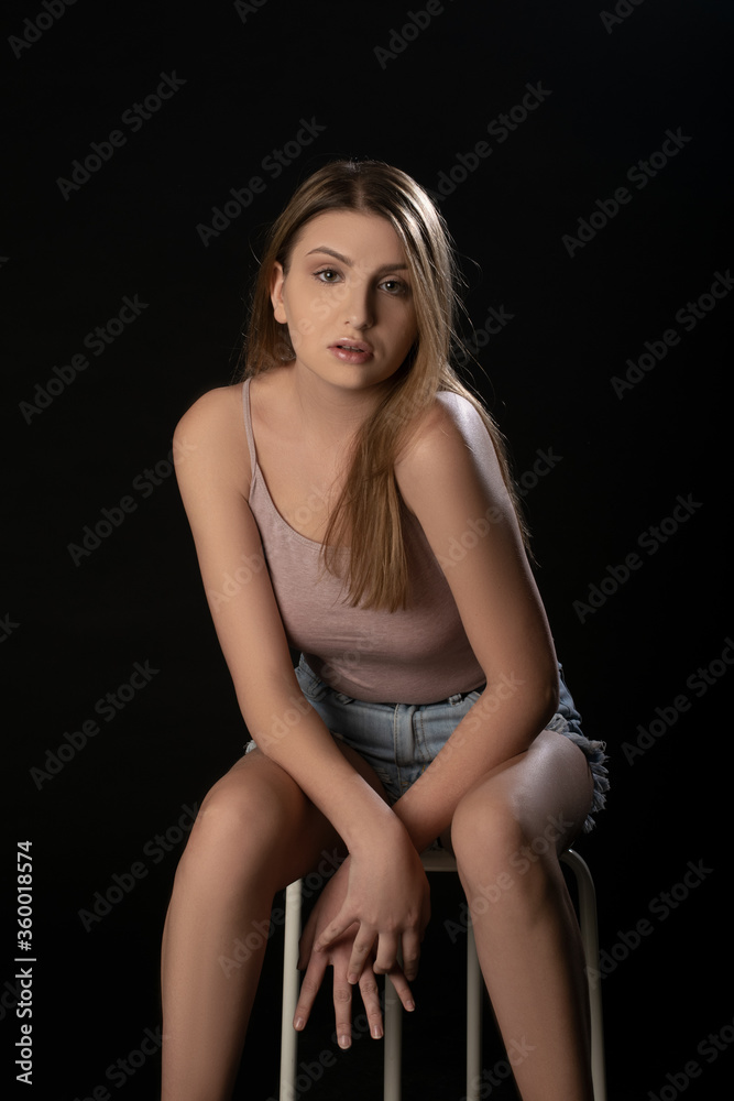 Beautiful girl posing on black background. Isolated, Face Expression Beautiful girl posing on black background. Isolated, Face Expression