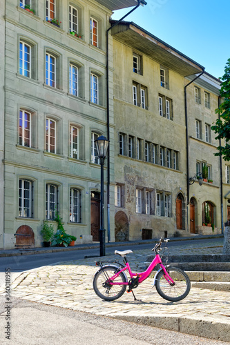 Pink bicycle in the historic district of Fribourg (Freiburg), Switzerland