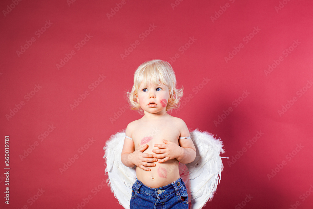 Adorable little angel boy with feather wings Adorable little angel boy with feather wings